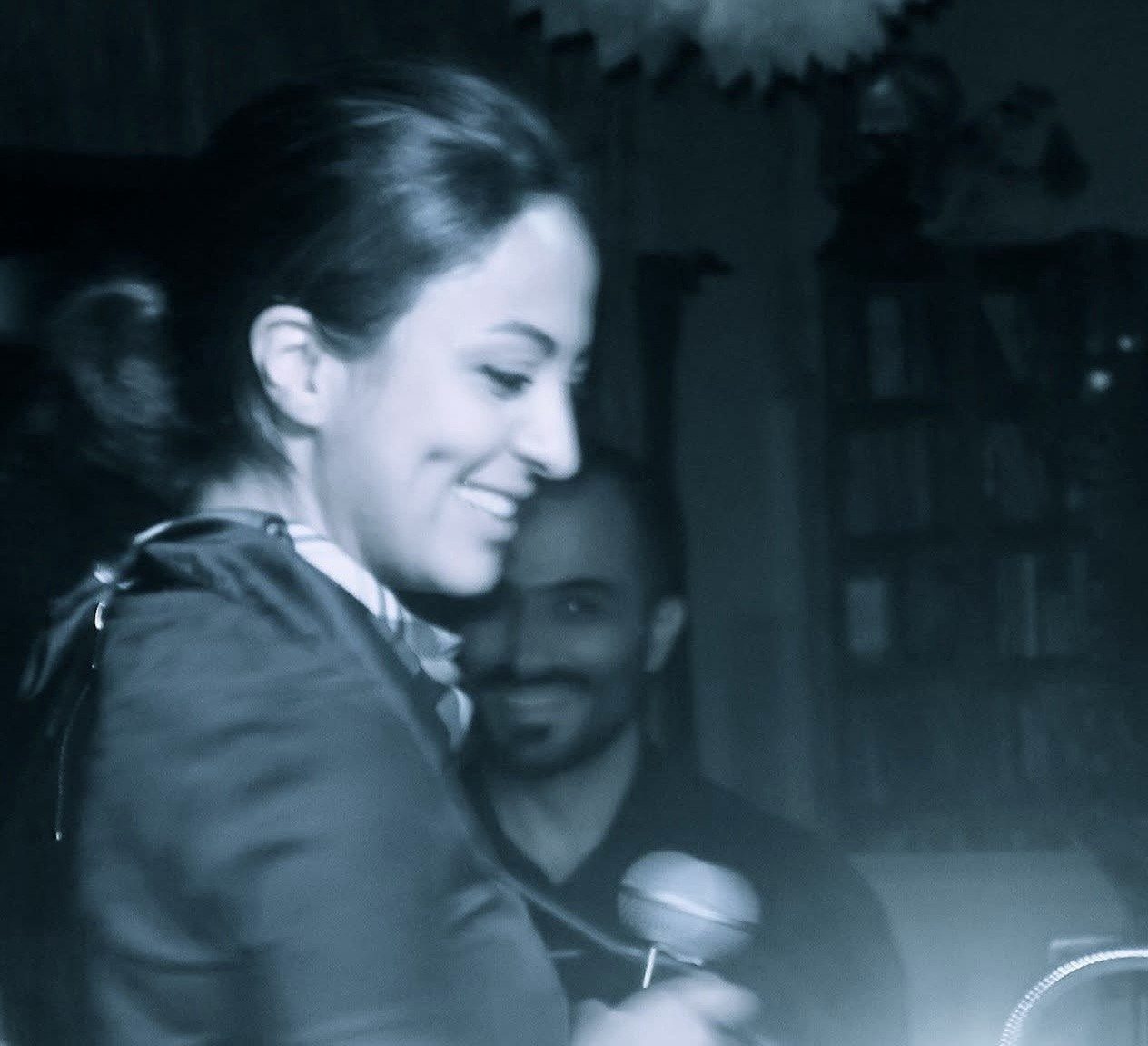 Nasim holding a microphone during E4LA media and music events from 2018 through 2021